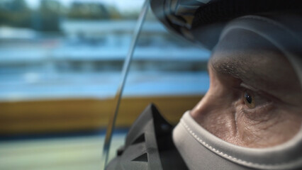 Professional racing driver speeding on track, close-up on eyes behind helmet visor, symbolizing...