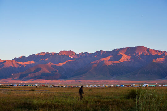 Wetland grassland and Tianshan Mountain scenery in twilight at Sayram Lake, Xinjiang, China