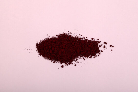 Heap of Azorubine or Carmoisine powder. Food additive E122, azo dye. In addition to food industry, red controversial dye used in cosmetology, perfumery and in production of drugs