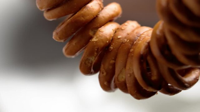 Hanging bunch of salted pretzel crackers. Macro shot