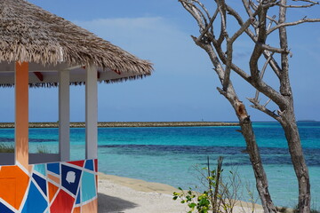 A colorful beach hut by the turquoise sea on the island Guraidhoo in the Maldives
