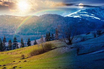 mountainous countryside landscape on spring equinox. day and night time change. grassy field on...