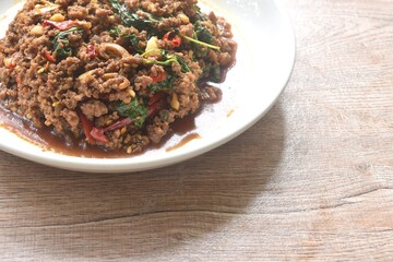 spicy stir fried chop beef meat with chili and basil on plate