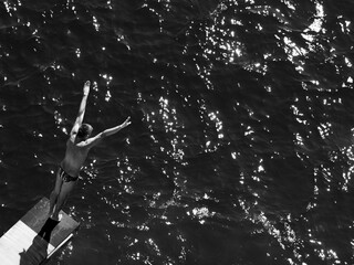a male professional swimmer about to dive into the sea