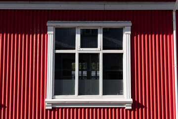 Fototapeta premium House with red exteior wall and white window.