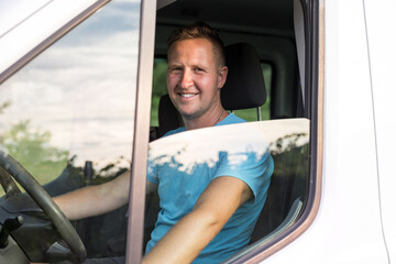 Smiling Man Driving a Vehicle and Looking Out