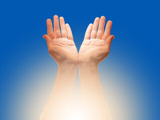 Two open hands raised toward the sky with glowing light below, symbolizing prayer, gratitude,...