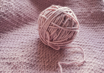 A Beautifully Soft Knit Yarn Ball is Positioned on a Cozy Piece of Fabric, Exuding Warmth