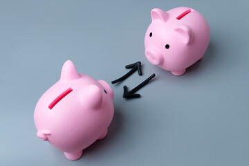 Two piggy banks and arrows symbolizing an exchange or transfer. Exchange or trading of assets...