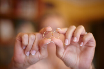 Woman's hands holding two engagement rings