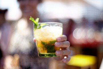 Woman's hand holding a mojito