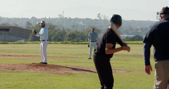 Pitcher glancing at first baseman on mound winding up and releasing baseball striking out batter