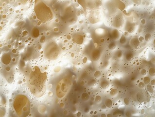 Close-up view of a foamy texture with large bubbles created by fermentation in a craft brewing process