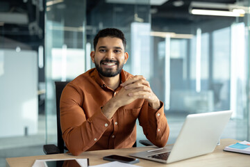 Smiling professional sitting at desk in a modern office environment
