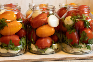 green parsley, onion rings and spices in yellow and red tomatoes filled with them are waiting to be poured with marinade