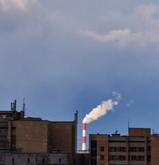 Industrial Smokestack Above Residential Buildings