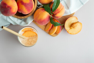 Fresh peaches on the table with a glass of creamy peach yogurt smoothie. Protein shake with peach milkshake. 