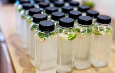 Plastic bottles filled with sparkling lime mint water.