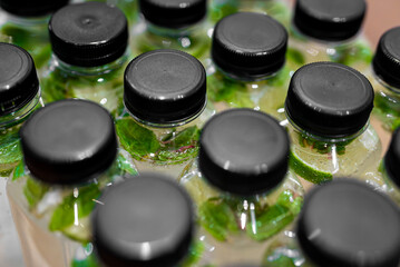 Plastic bottles filled with sparkling lime mint water.
