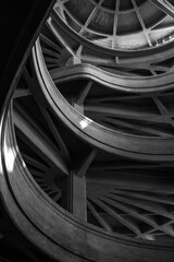 Monochrome image showcasing intricate curves and geometric design of a modern concrete structure.