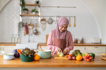 Muslim woman wearing hijab preparing fresh vegetables and fruits in kitchen, healthy lifestyle clean eating cooking, wellness and tradition, nutrition family care, vitamins supplement, halal cooking