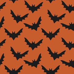 Seamless pattern of black bats on an orange background, perfect for Halloween, spooky themes, or autumn designs.