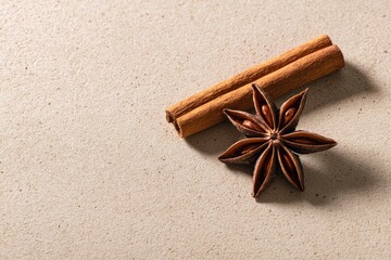 Star Anise and Cinnamon Sticks on Textured Surface for Culinary and Aromatic Inspirations in Cooking and Baking
