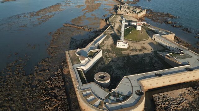 Aerial perspective of Avanzada de Santa Isabel in Cadiz, southern Spain. Flying forwards.