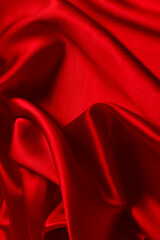 Obraz premium Red silk or satin luxury fabric texture can use as abstract background. Top view.