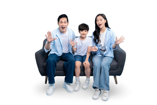 Family of three sitting together happily. Family expressing excitement sitting on the sofa on PNG - Powered by Adobe