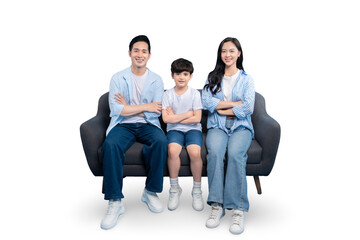 Happy family sitting together on a gray sofa in a home setting. The image captures a moment of...