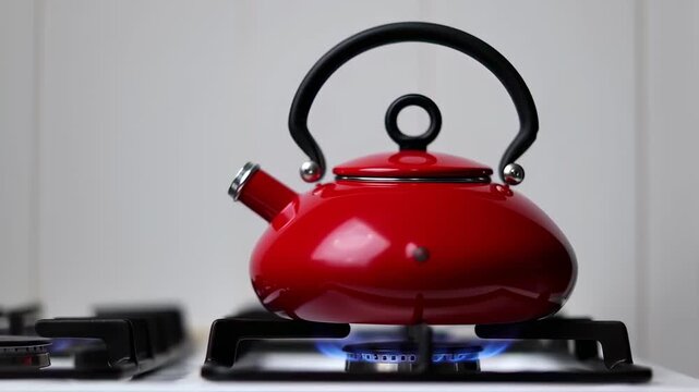 Red kettle on a gas stove