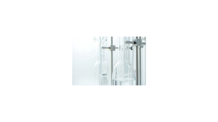 Sterile laboratory glassware setup with a transparent chemical flask held by a clamp on a retort stand against a bright white background for scientific research.