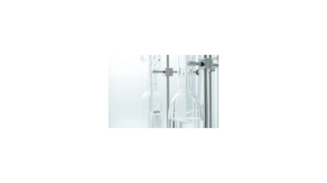 Sterile laboratory glassware setup with a transparent chemical flask held by a clamp on a retort stand against a bright white background for scientific research.