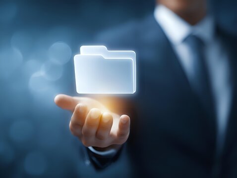 African American businessman in suit holding glowing digital folder icon floating above palm against blue bokeh background, representing data management.
