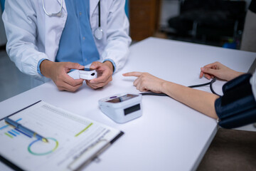A doctor is showing a patient a blood pressure monitor