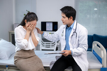 Obraz premium A woman is crying in a hospital bed while a doctor sits next to her