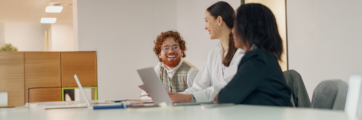 An eclectic and diverse team actively engages in a spirited discussion during an important business...