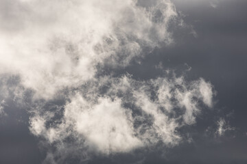 Dramatic Sky with Bright Clouds against Dark Overcast Background 