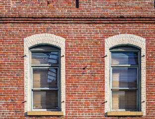 Victorian Style Red Brick Building with Twin Arched Windows.