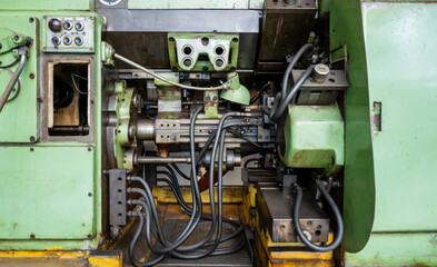 Green Industrial Machine Interior with Hydraulic Systems and Control Panel Components