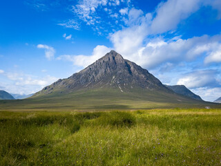 Fototapeta premium Solitary Mountain Peak Beneath a Clear Blue Sky