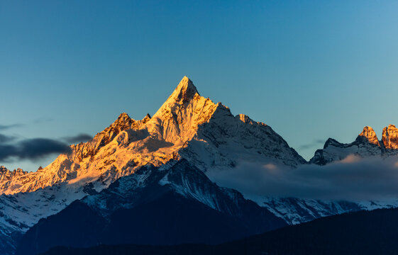 Aerial view of the Golden Mountain bathed in sunlight on Meili Snow Mountain in Yunnan Province	 - Powered by Adobe