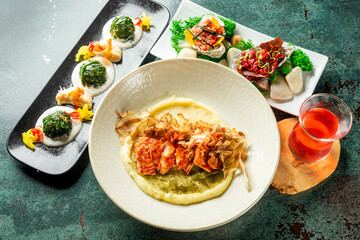 Gourmet food assortment on elegant plates with artistic presentation, including greens, salmon, creamy base, and a red drink. Fine dining concept with vibrant colors and textures.