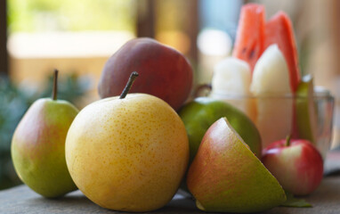 Various autumn fruits are placed under the window.
