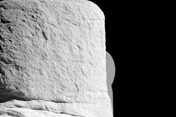 Close-up of textured, light gray stone pillar