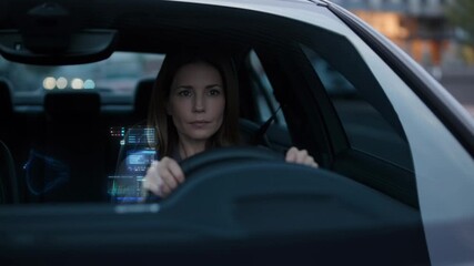 Professional businesswoman interacting with augmented reality head up display while navigating autonomous vehicle during nighttime urban commute - Powered by Adobe