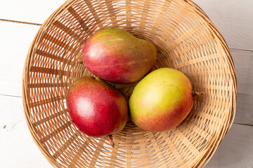Sweet juicy mangoes on a  table, top view, macro.