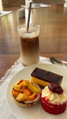 breakfast with coffee and croissant Bowl of fruit salad Delicious ripe mango fruit slices and cubes on plate for healthy eating and tropical dessert recipe Fresh fruit in a wooden bowl. Concept of hea