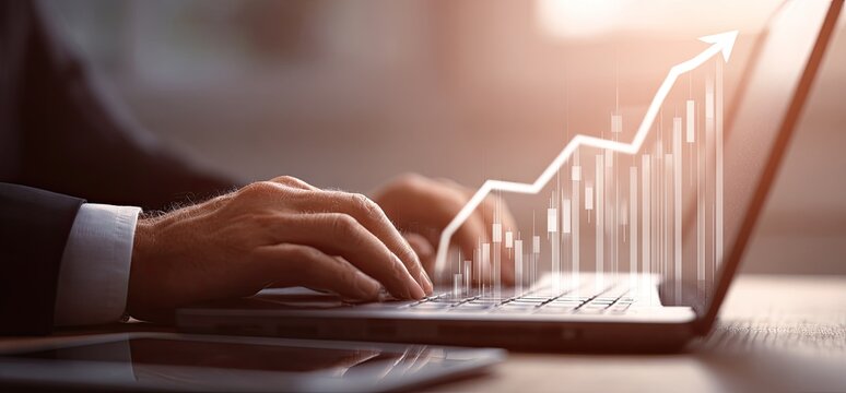 Businessperson working on a laptop with a graph overlaid showing upward trend